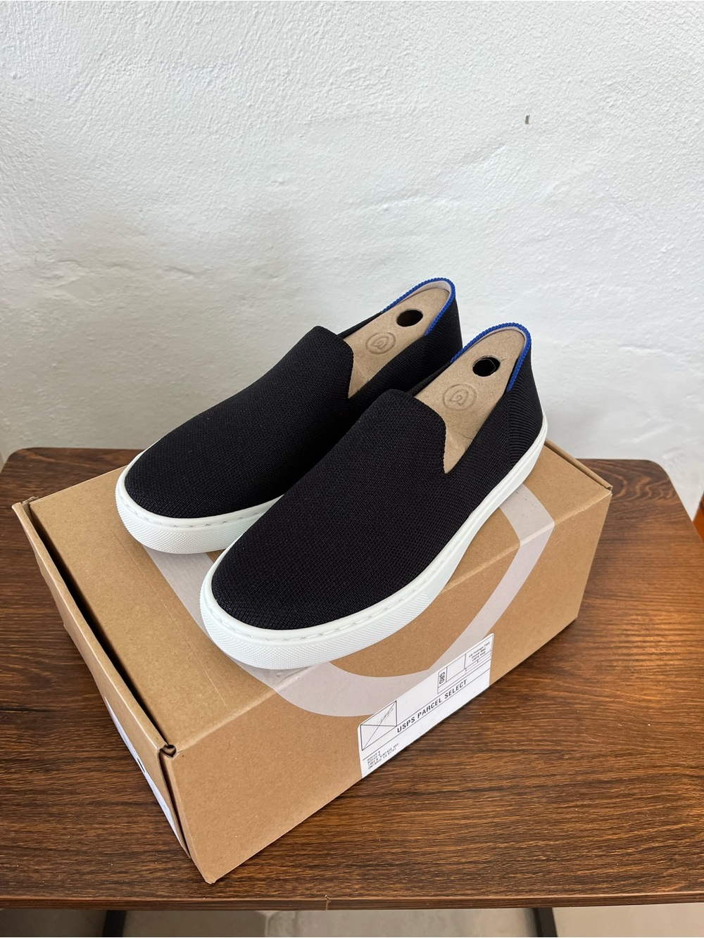Rothy's Black Slip-On Sneakers with Blue Trim